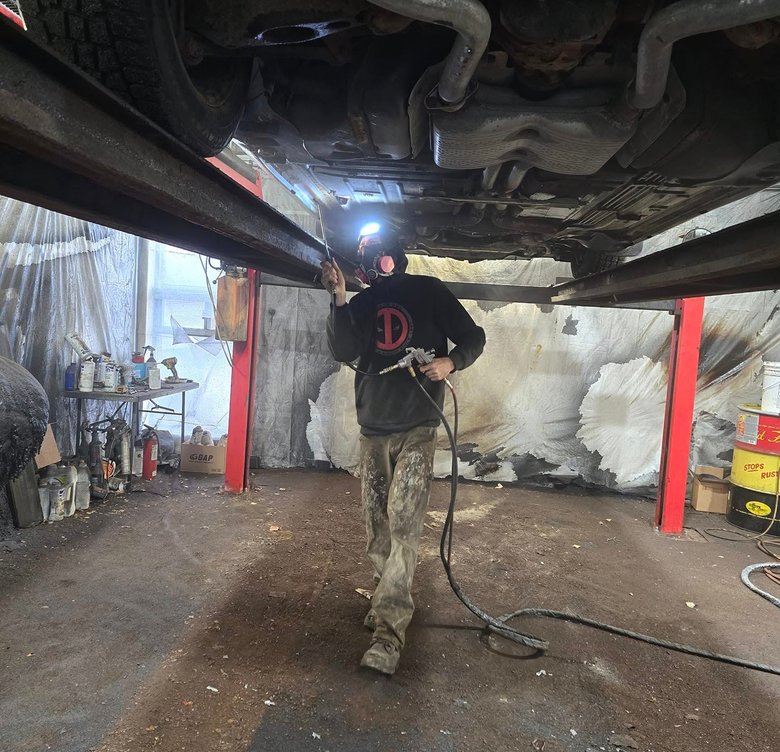 technician spraying undercarriage